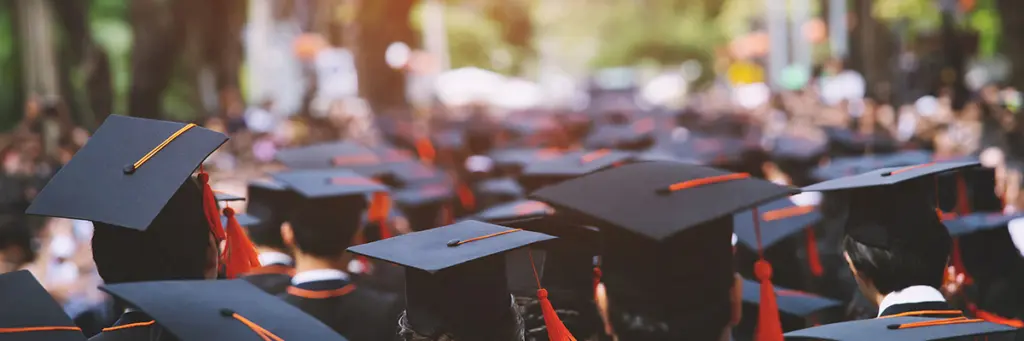 Who Pays for University Fees Following Separation and Divorce? - Picture of University graduates mortar boards.