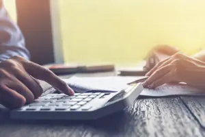 Who Pays for University Fees Following Separation and Divorce? - Picture of divorced parents calculating finances.